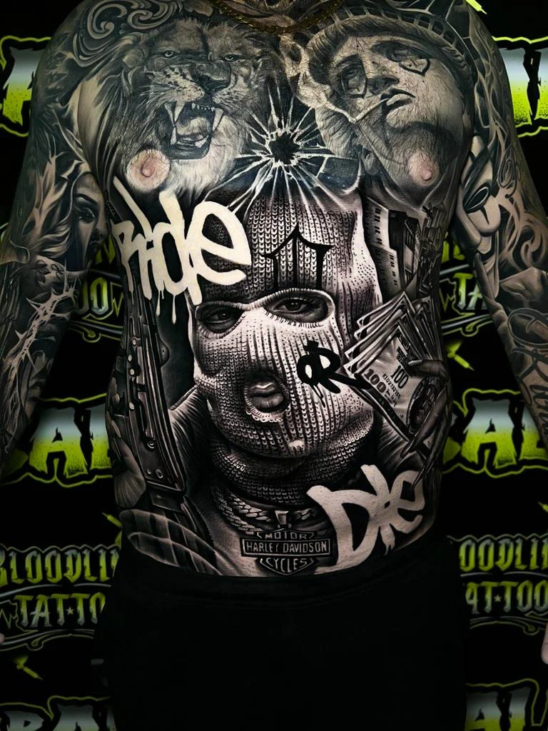 Detailed black and grey Chicano full back tattoo with a ski mask portrait, lion head, Statue of Liberty, cash stacks, and rifle at Bloodline Tattoo Bali.