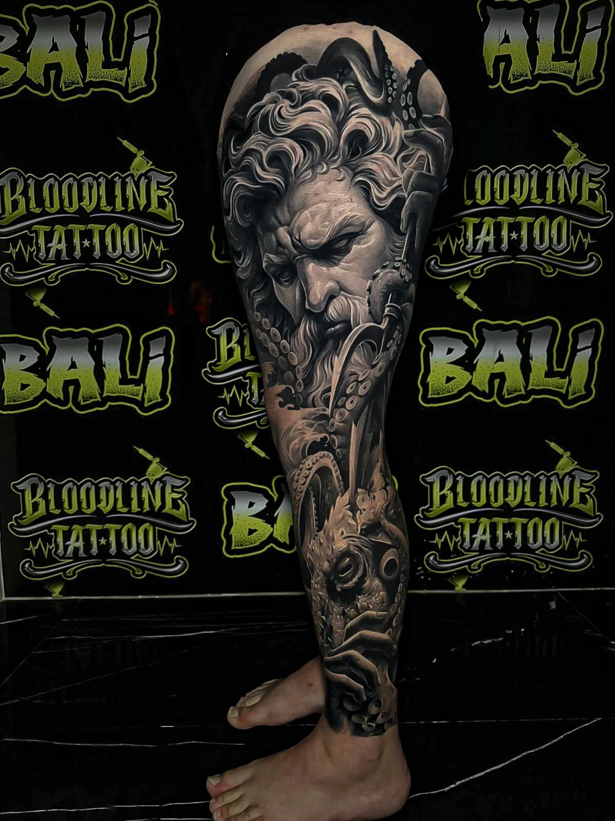 Healed mythological leg sleeve with a bearded sea god, octopus tentacles, and underwater realism, showing soft healed shading at Bloodline Tattoo Bali.